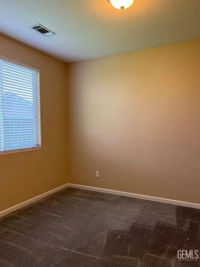5413 Ridgecrest Ct, Bakersfield, CA 93313 - spare room featuring dark carpet and baseboards