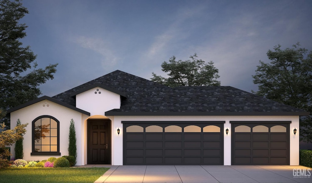 view of front facade featuring an attached garage, stucco siding, concrete driveway, and roof with shingles