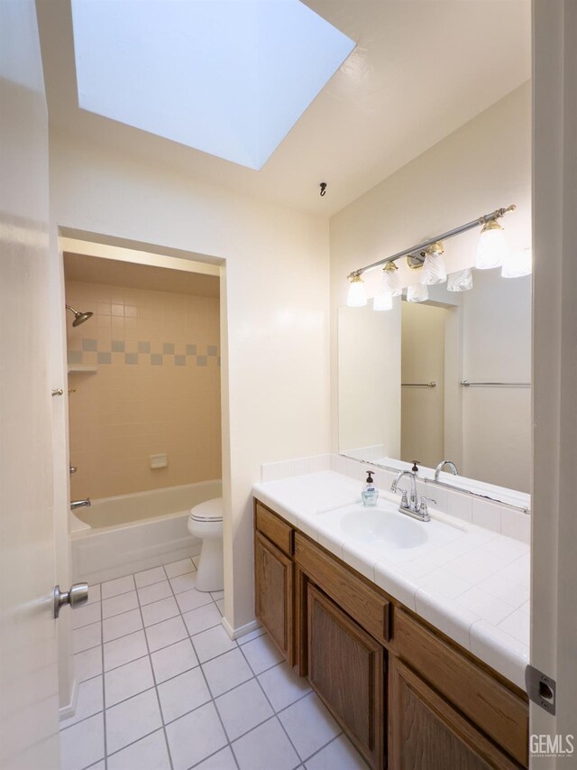 full bathroom with tiled shower / bath combo, tile patterned flooring, vanity, and toilet