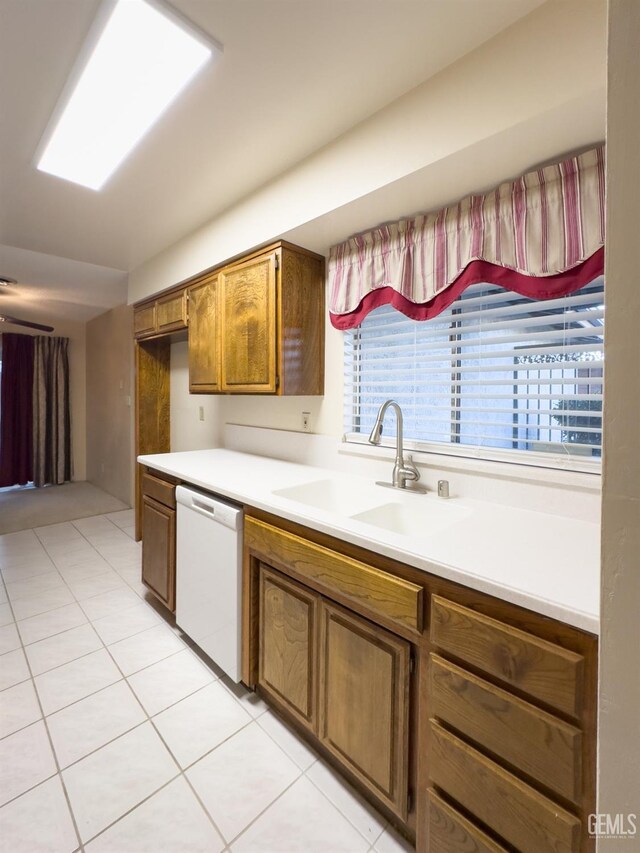 kitchen with sink, light tile patterned floors, and dishwasher