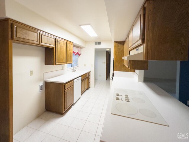 kitchen with sink, light tile patterned floors, and white dishwasher