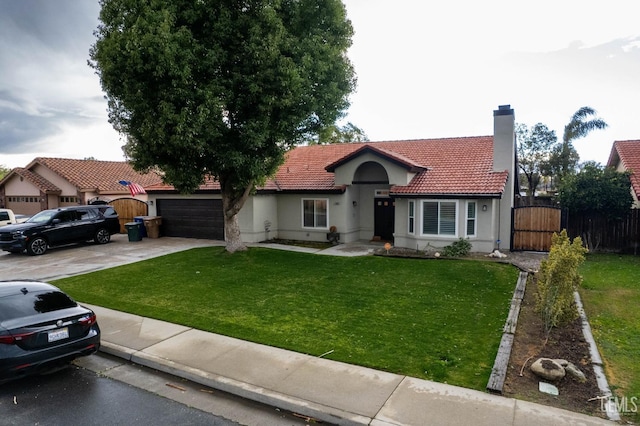 mediterranean / spanish home featuring a garage and a front yard