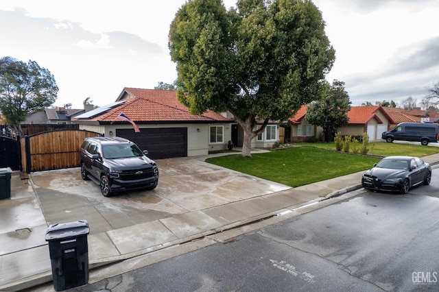 view of front of home with a garage and a front lawn