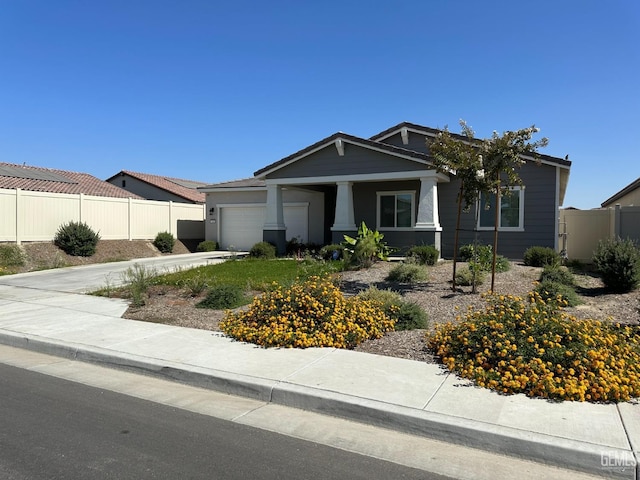 7410 Koyuk River St, Bakersfield, CA 93311 - view of front of home with an attached garage, concrete driveway, and a porch