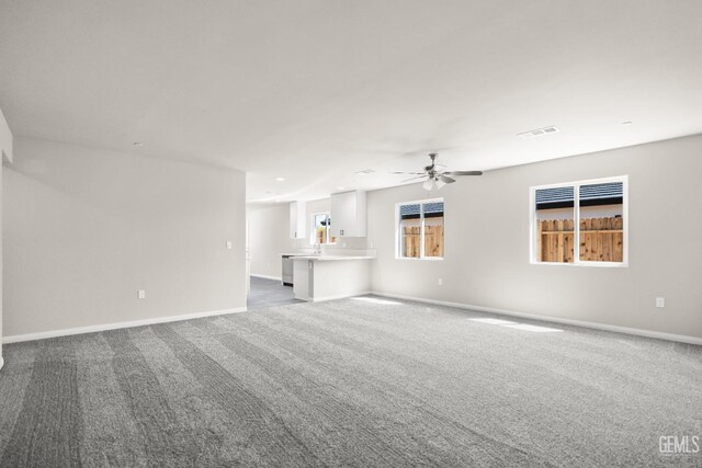 601 Poinsettia St, Bakersfield, CA 93307 - unfurnished living room with visible vents, dark carpet, baseboards, recessed lighting, and a ceiling fan