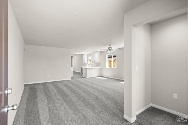 601 Poinsettia St, Bakersfield, CA 93307 - unfurnished living room featuring baseboards, ceiling fan, and carpet flooring