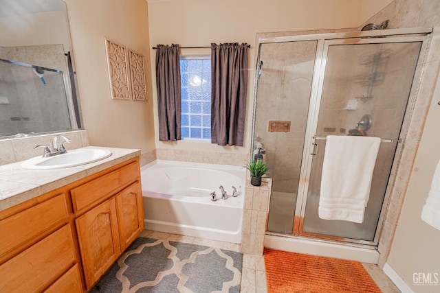 bathroom featuring vanity and shower with separate bathtub