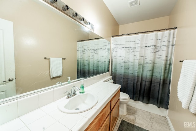 bathroom with vanity, toilet, and walk in shower