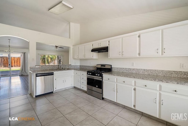 3502 Southpass Dr, Bakersfield, CA 93312 - kitchen with stainless steel appliances, under cabinet range hood, white cabinets, light tile patterned floors, and a ceiling fan