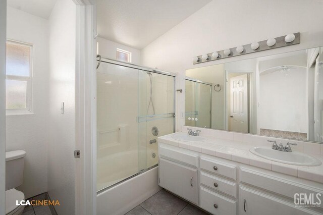 3502 Southpass Dr, Bakersfield, CA 93312 - full bath featuring double vanity, enclosed tub / shower combo, plenty of natural light, and tile patterned flooring
