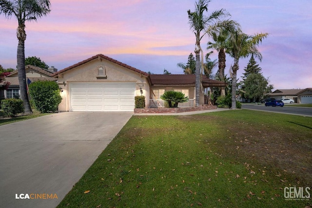 3502 Southpass Dr, Bakersfield, CA 93312 - ranch-style home featuring stucco siding, a front yard, a garage, driveway, and a tile roof