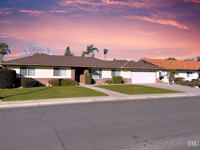 ranch-style house with a front lawn and a garage