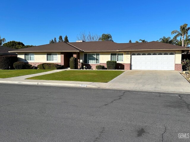 single story home with a front yard and a garage