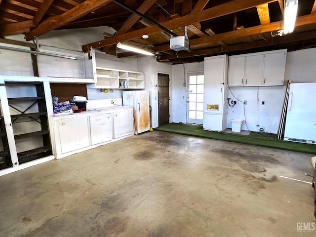 garage with white fridge and a garage door opener