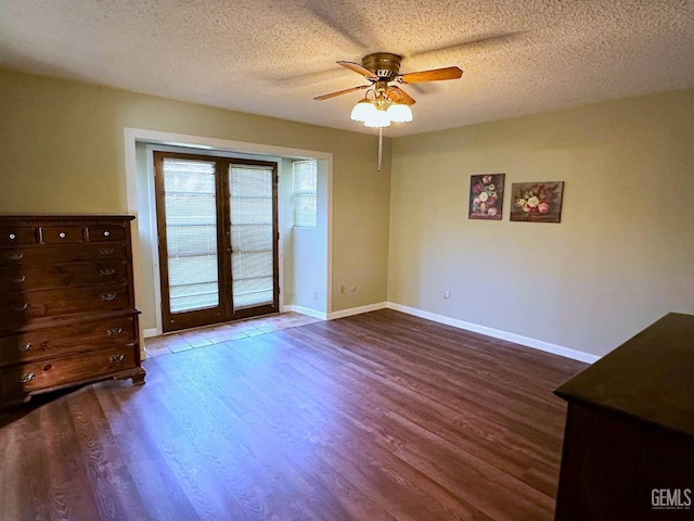 empty room featuring ceiling fan, french doors, a textured ceiling, and wood-type flooring