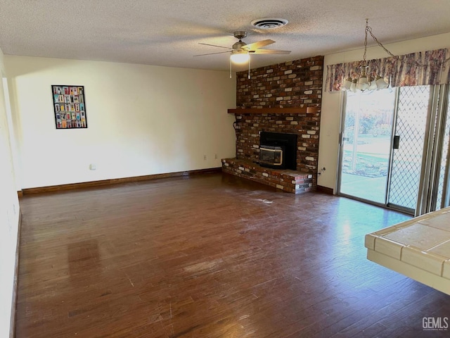 unfurnished living room featuring a textured ceiling, ceiling fan, and dark hardwood / wood-style flooring