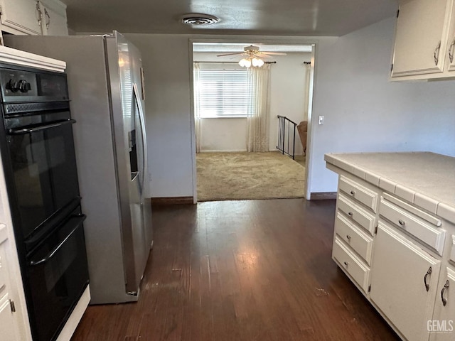 kitchen featuring ceiling fan, white cabinetry, dark hardwood / wood-style flooring, and tile countertops