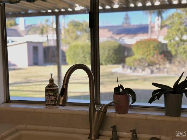 kitchen with dishwasher, sink, kitchen peninsula, tile countertops, and ceiling fan