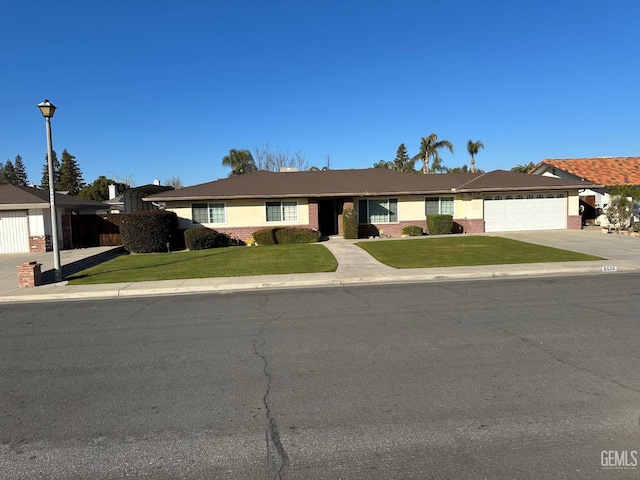 single story home featuring a front yard and a garage