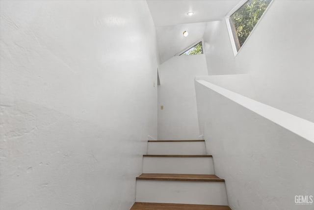 stairway with vaulted ceiling