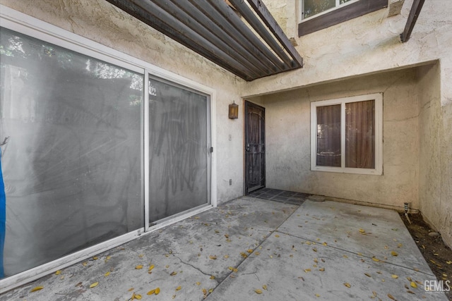 entrance to property featuring a patio