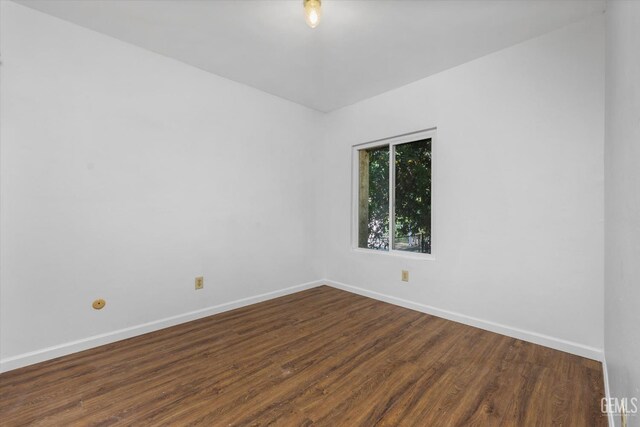 spare room with dark hardwood / wood-style floors