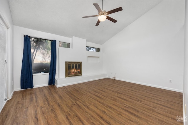 unfurnished living room with ceiling fan, dark hardwood / wood-style flooring, and high vaulted ceiling