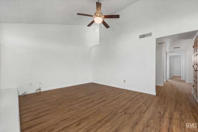 spare room with dark hardwood / wood-style floors, ceiling fan, and lofted ceiling