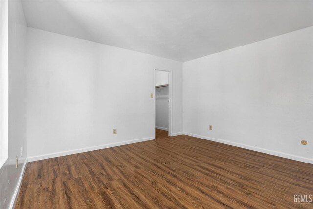 spare room with dark wood-type flooring