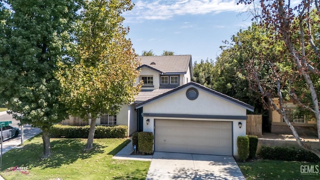 view of front of home featuring a garage and a front yard