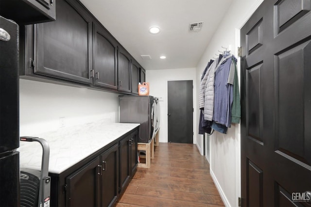 interior space featuring baseboards, visible vents, dark wood finished floors, light countertops, and recessed lighting