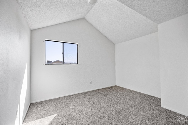 additional living space featuring vaulted ceiling, a textured ceiling, and carpet flooring