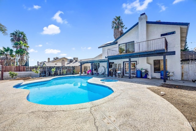 view of pool featuring an in ground hot tub, a patio area, fence, and a fenced in pool