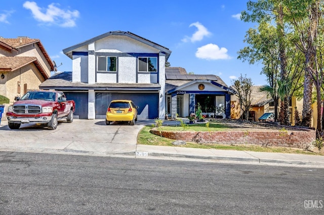 traditional-style home featuring an attached garage, solar panels, concrete driveway, and stucco siding