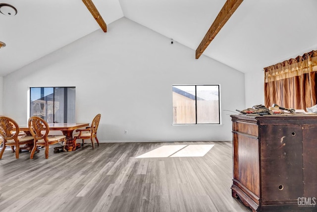 interior space featuring high vaulted ceiling, beam ceiling, and light wood finished floors