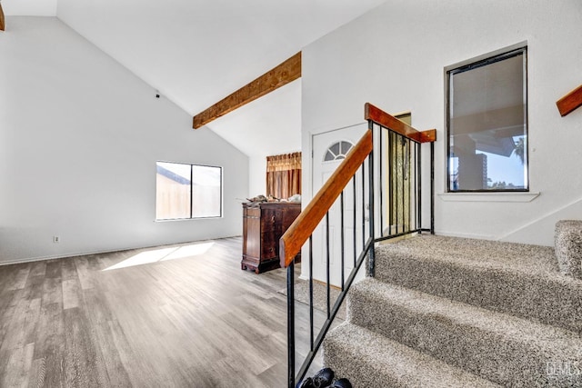 staircase featuring high vaulted ceiling, beamed ceiling, and wood finished floors