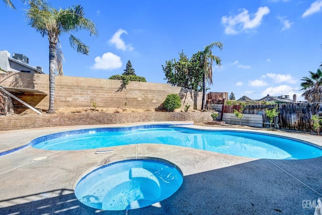 view of pool with a fenced in pool, a fenced backyard, and an in ground hot tub