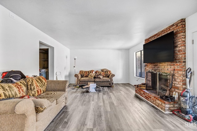 living room featuring a fireplace and wood finished floors