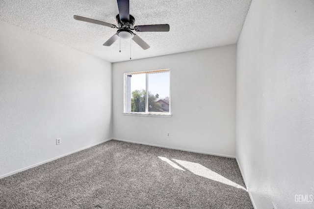 carpeted empty room featuring baseboards, a ceiling fan, and a textured ceiling