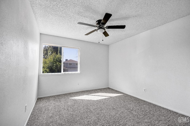 unfurnished room with carpet floors, a textured wall, a textured ceiling, and a ceiling fan