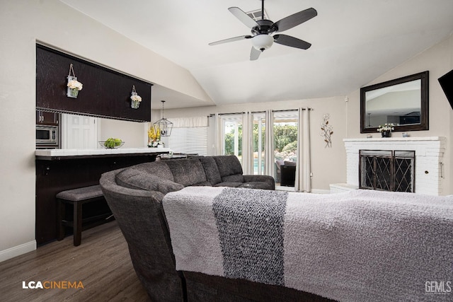 10707 Mohican Dr, Bakersfield, CA 93312 - living room featuring vaulted ceiling, wood finished floors, baseboards, a ceiling fan, and a fireplace