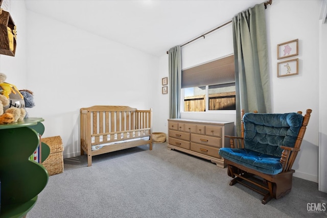 carpeted bedroom with a crib