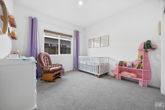 bedroom with carpet floors and a crib