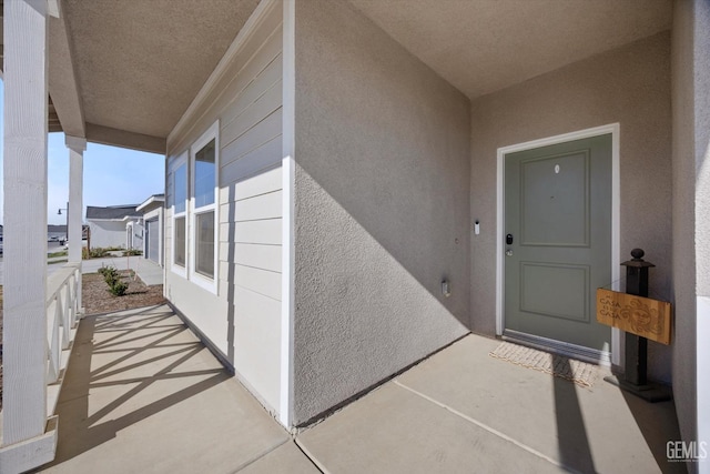 doorway to property featuring covered porch