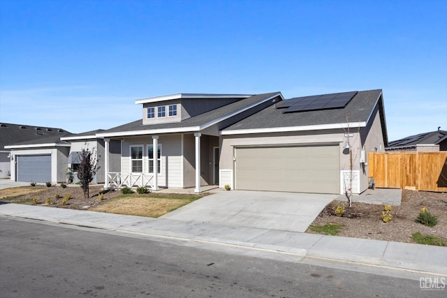 view of front of property with solar panels and a garage