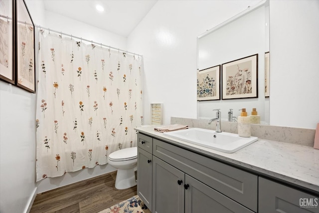 full bathroom with toilet, vanity, shower / tub combo with curtain, and hardwood / wood-style floors