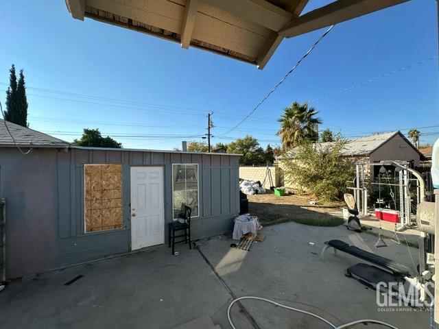 view of patio with an outbuilding