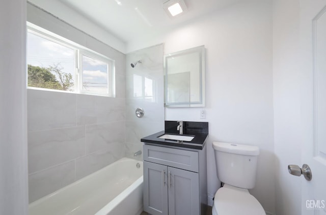 bathroom featuring toilet, bathtub / shower combination, and vanity