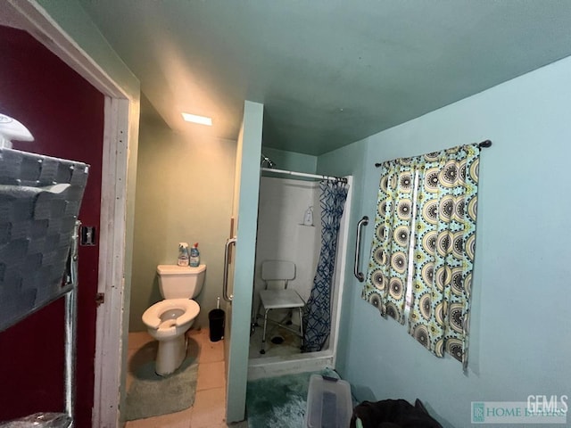 full bath featuring tile patterned flooring, a stall shower, and toilet