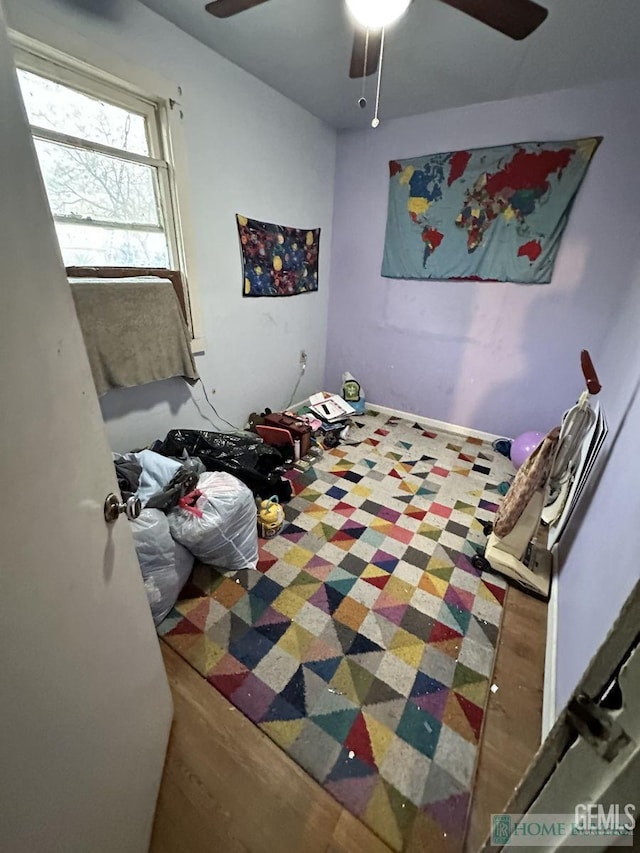 bedroom featuring a ceiling fan and wood finished floors